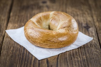 Plain Bagel (selective focus) on vintage background (close-up shot)