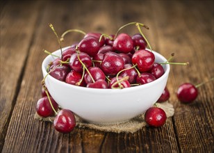 Fresh Cherries on an old wooden table as detailed close-up shot, selective focus