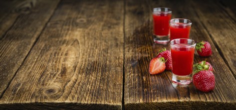 Homemade Strawberry liqueur on vintage background selective focus, close-up shot