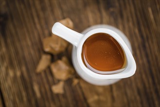 Portion of fresh Caramel Sirup (close-up shot, selective focus)