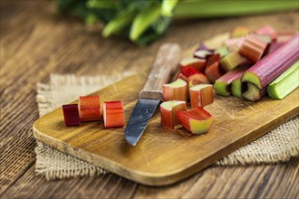 Chopped Rhubarb on an old wooden table (close up shot, selective focus)