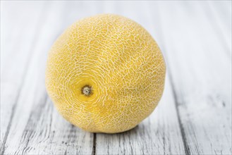 Honeydew Melon on an old wooden table as detailed close-up shot (selective focus)