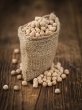 Chickpeas on an old wooden table as detailed close-up shot, selective focus