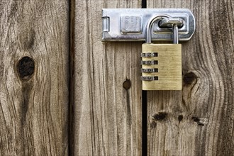 Golden padlock on a wooden Tor tor