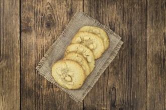 Vintage wooden table with Cookies (selective focus, close-up shot)