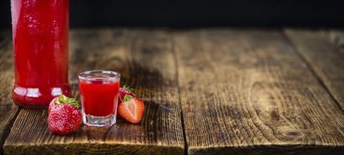 Some homemade Strawberry liqueur as detailed close-up shot, selective focus