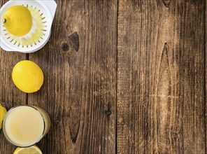 Homemade Lemon Juice on an wooden table (selective focus) as detailed close-up shot