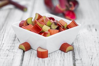 Chopped Rhubarb on an old wooden table (close up shot, selective focus)