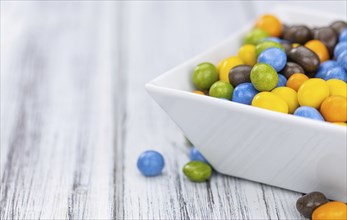 Chocolate coated peanuts as detailed close up shot (selective focus)