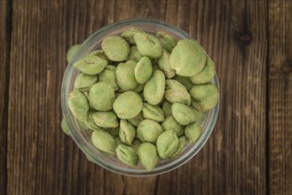 Wasabi Peanuts on a vintage background as detailed close-up shot (selective focus)