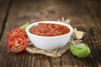 Fresh made Pasta Sauce (Tomato taste) on a vintage background (close-up shot)