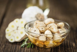 Fresh made Garlic (preserved) on a vintage background (close-up shot)