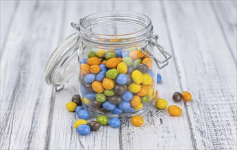 Portion of sweets (chocolate coated peanuts) as detailed close-up shot, selective focus