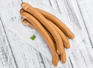 German Sausages (Wiener) as high detailed close-up shot on a vintage wooden table (selective focus)