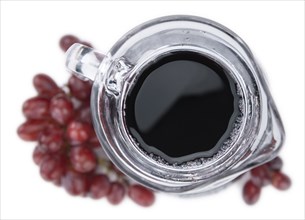 Red Grape Juice isolated on white background (selective focus, close-up shot)
