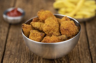 Homemade Chicken Nuggets on vintage background (selective focus, close-up shot)