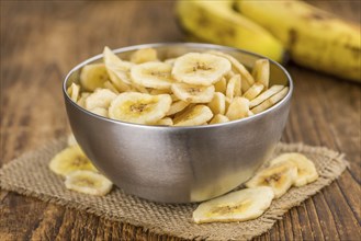 Portion of fresh Dried Banana Chips close-up shot, selective focus