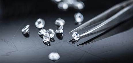 Small Diamonds on dark background as close up shot (selective focus)