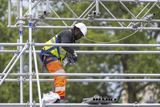 Scaffolders at work, erecting a large scaffold, grandstands for the Olympic Games, Place de la