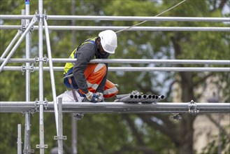 Scaffolders at work, erecting a large scaffold, grandstands for the Olympic Games, Place de la