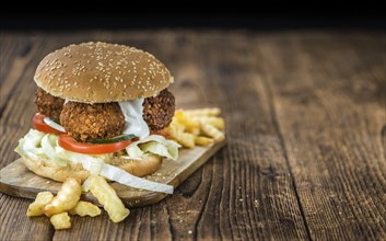 Homemade Falafel Burger (detailed close-up shot, selective focus) on a wooden table