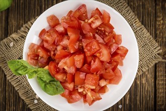 Homemade Cutted Tomatoes on vintage background (selective focus, close-up shot)