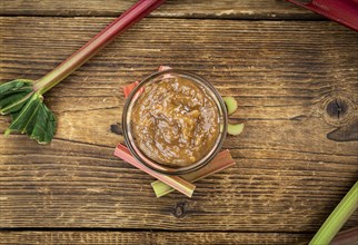 Rhubarb Jam on an old wooden table as detailed close up shot (selective focus)