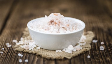 Pink Salt on a vintage background as detailed close-up shot (selective focus)