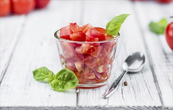 Diced Tomatoes on a vintage background as detailed close-up shot (selective focus)