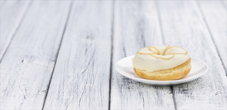 Some fresh made white chocolate Donuts (selective focus, close-up shot)