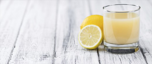 Lemon Juice on a vintage background as detailed close-up shot (selective focus)