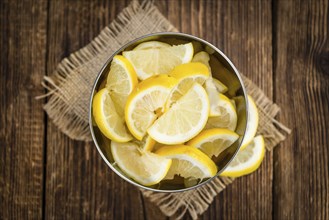 Homemade Lemon Slices on an wooden table (selective focus) as detailed close-up shot