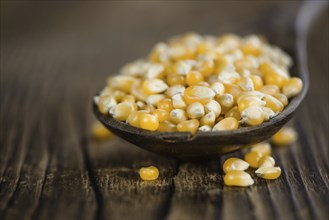 Wooden table with a portion of Corn (selective focus, close-up shot)