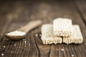 Fresh made Quinoa Bars (selective focus, close-up shot) on an old wooden table