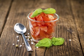 Homemade Cutted Tomatoes on vintage background (selective focus, close-up shot)