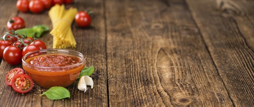 Pasta Sauce (Tomato taste) as high detailed close-up shot on a vintage wooden table (selective