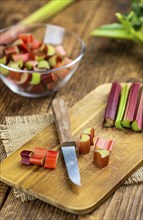 Chopped Rhubarb on an old wooden table (close up shot, selective focus)