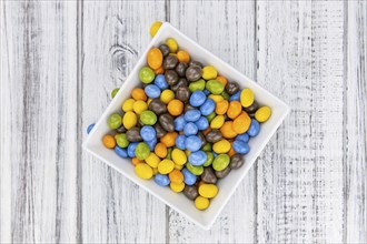 Chocolate coated peanuts as detailed close up shot (selective focus)