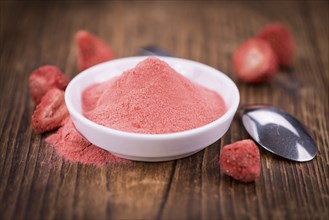 Fresh made Strawberry powder on a vintage background as detailed close-up shot