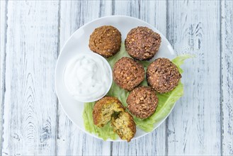 Portion of Falafel on an old wooden table (close-up shot, selective focus)