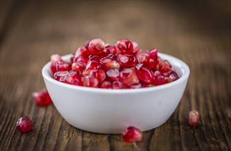 Pomegranate on a vintage background as detailed close-up shot (selective focus)