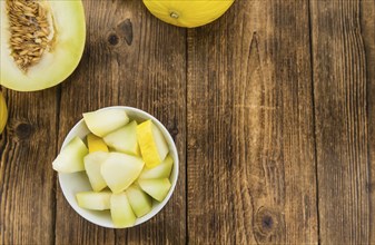 Honeydew Melon on rustic wooden background (close-up shot)