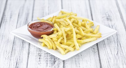Portion of fresh made crispy French Fries (selective focus, close-up shot)