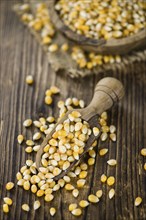 Wooden table with a portion of Corn (selective focus, close-up shot)