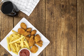 Homemade Chicken Nuggets on vintage background (selective focus, close-up shot)