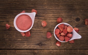 Fresh made Strawberry powder on an old and rustic wooden table, selective focus, close-up shot