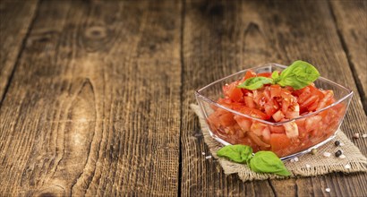 Diced Tomatoes on a vintage background as detailed close-up shot (selective focus)