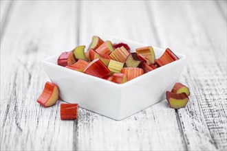 Chopped Rhubarb on an old wooden table (close up shot, selective focus)