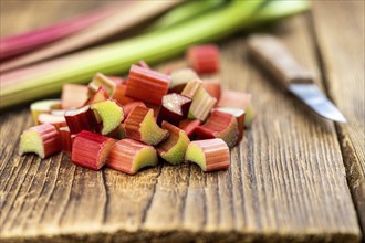 Chopped Rhubarb on an old wooden table (close up shot, selective focus)