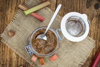 Rhubarb Jam on an old wooden table as detailed close up shot (selective focus)